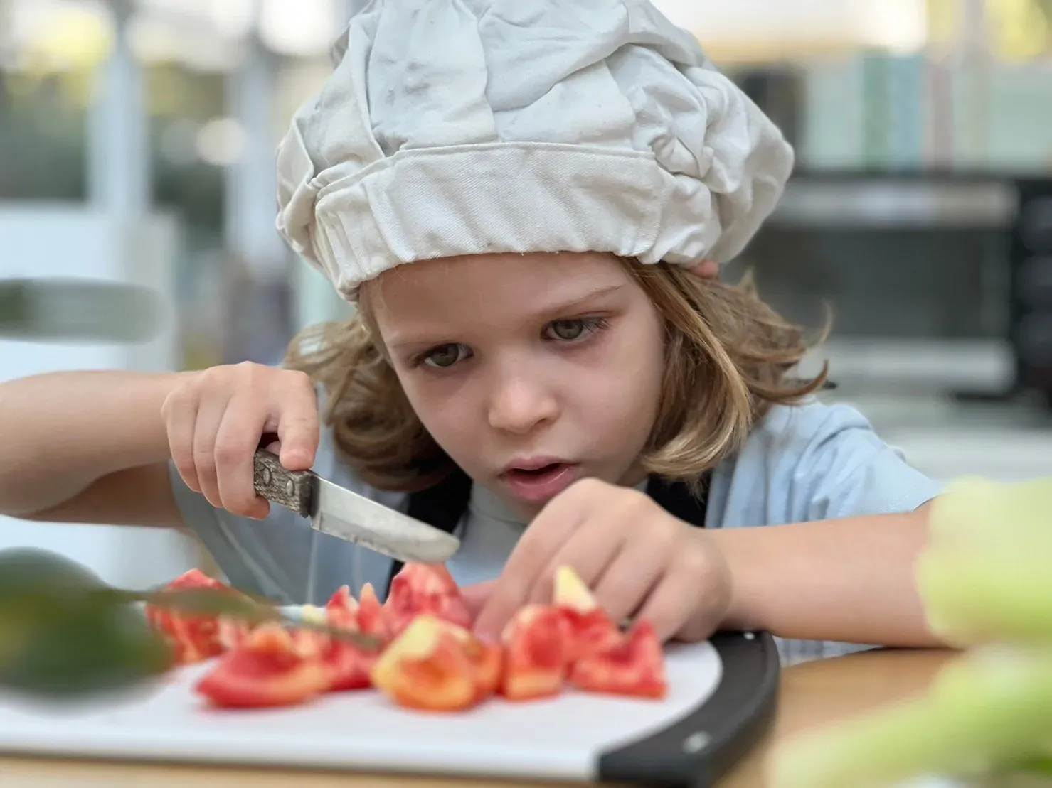 A child presenting the dish they have made