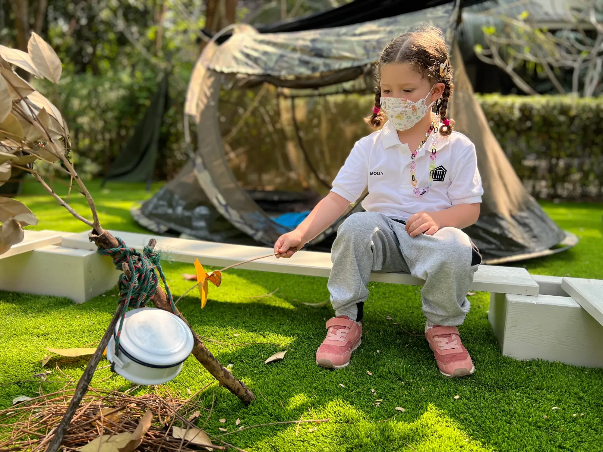 Children learning outdoors in the Dusit campus garden
